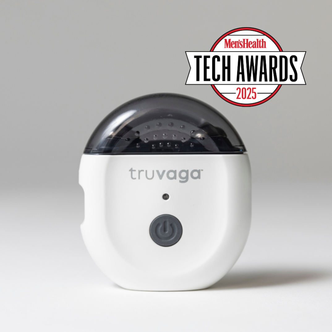 A white Truvaga Vagus Nerve Stimulator with a power button, marked "truvaga," features a dark translucent top and the "Men’s Health Tech Awards 2025" logo, designed to enhance mental clarity and relieve stress.