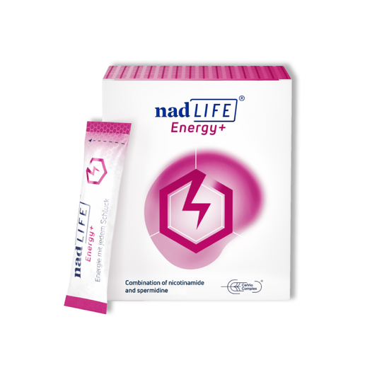 Product packaging for nadLIFE - 30 Servings by spermidineLIFE showcases a sleek white and pink box alongside a single pink stick pack. The text on the box highlights it as an advanced energy booster, combining niacin (nicotinamide) and spermidine to enhance cell regeneration.