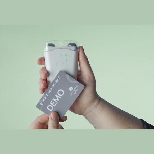 A person holding a device with a gammaCore Vagus Nerve 3-month Refill Card by ElectroCore in it.