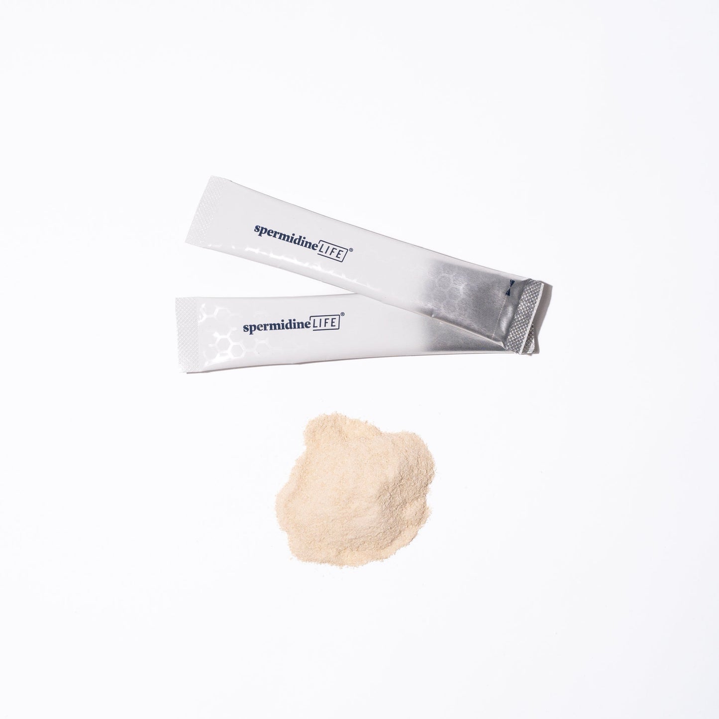 A packet of spermidineLIFE® Pro+ 4800mg 10 Pack from Longevity Labs, Inc and a powder next to each other on a white surface.