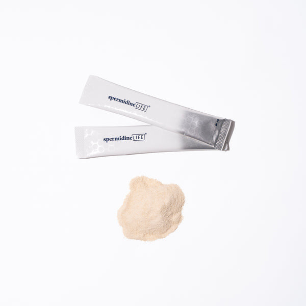 A spermidineLIFE bag with a SpermidineLife PRO+ 4800mg | 30 Pack powder next to it on a white surface.